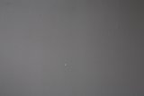 Tiny White Dot on Textured Wall