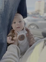 Baby in Car Seat with Dappled Sunlight