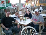 Four Men Enjoying Beer and Food at a Restaurant