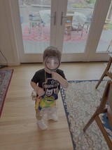 Child Playing Detective with Magnifying Glass