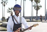 Turbaned Guitarist Serenading under the Palms
