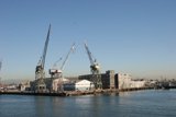 Busy Harbor with Cranes and Ships