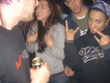 Black Shirted Man Enjoys a Drink with Friends