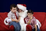 Santa Claus and Two Boys on a Festive Red Couch