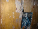 Artistic Collage of Posters and Pictures on Plywood Wall