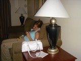 Woman Relaxing on Hotel Couch with Handheld Device