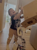 Child Joyfully Playing with Kitchen Utensils at Home