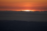 Fiery Sunset Ignites the Horizon Beyond Bay Clouds