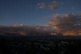 Clouds rolling in over the city at sunset