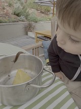 Young Child Enjoying Outdoor Cooking Experience
