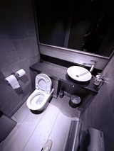 Modern Minimalist Bathroom with Dark Granite Countertops