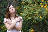 Woman in White Gazing Upward Among Yellow Wildflowers