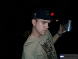 Lenny R enjoying a cold one Caption: Lenny R rocks his baseball cap and bracelet while savoring a refreshing beverage on a sunny day in 2003.