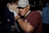 Grey Shirted Man with Baseball Cap and Timepiece