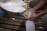 Pouring Milk into a Wooden Cup