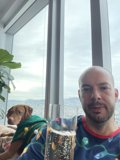 Man and Dog Enjoying a Beer by the Window