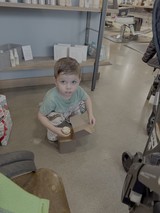 Young Boy Playing in Commercial Kitchen Setting