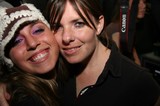 Two Friends Smiling Together at a Night Event