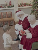 Santa Visits Child at Christmas Celebration