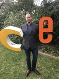 Dave B Holding Up the Letter D Outdoors