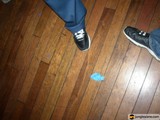 Blue Sneakers on Stained Wood Floor