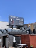 Weird Al Yankovic poses in front of "Weby Al Vanko" billboard on San Francisco rooftop