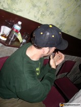 Man in Baseball Cap Relaxing on Couch