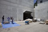 Group of People Outside Plywood Building