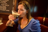 Woman Savoring a Creamy Martini at Upscale Bar