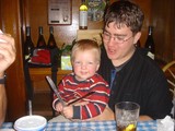 Toddler Grins Mischievously Holding Knife at Restaurant