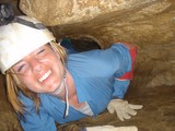 Caver Squeezes Through Tight Underground Passage Smiling