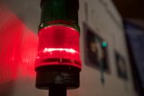 Red Traffic Light Illuminates Wall