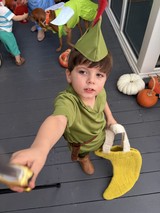 Young Boy in Peter Pan Costume at Halloween Party