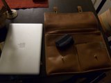 Laptop and Leather Bag on Table