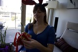 Penelope Unwrapping Christmas Gift with Reindeer Antlers