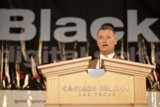Man addressing a crowd from a podium