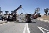 Crane Lifting Overturned Truck on the Street