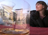 Woman Gazes at City Skyline Through Empty Glass