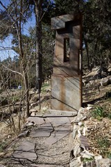 Weathered Metal Sculpture Gateway in Forest Garden