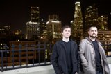 Two Men Enjoying the City Night View