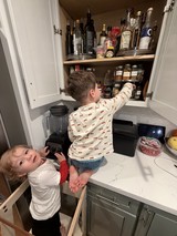Young Brothers Exploring Kitchen Cabinet Together