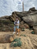 A Woman and Her Canine Companion at the Beach