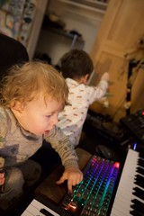 Young Child Captivated by Colorful Gaming Keyboard