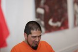 Contemplative Man in Orange