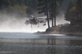 Helicopter Flying over a Tranquil Body of Water