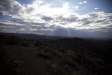 Sunlight Beaming Through Clouds Over a Desolate Desert