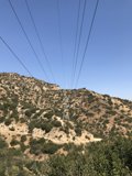 Power lines cutting through the majestic mountains