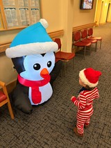 Toddler Meeting Inflatable Snowman at Holiday Event
