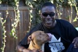 Smiling Man with Canine Companions and Sunglasses