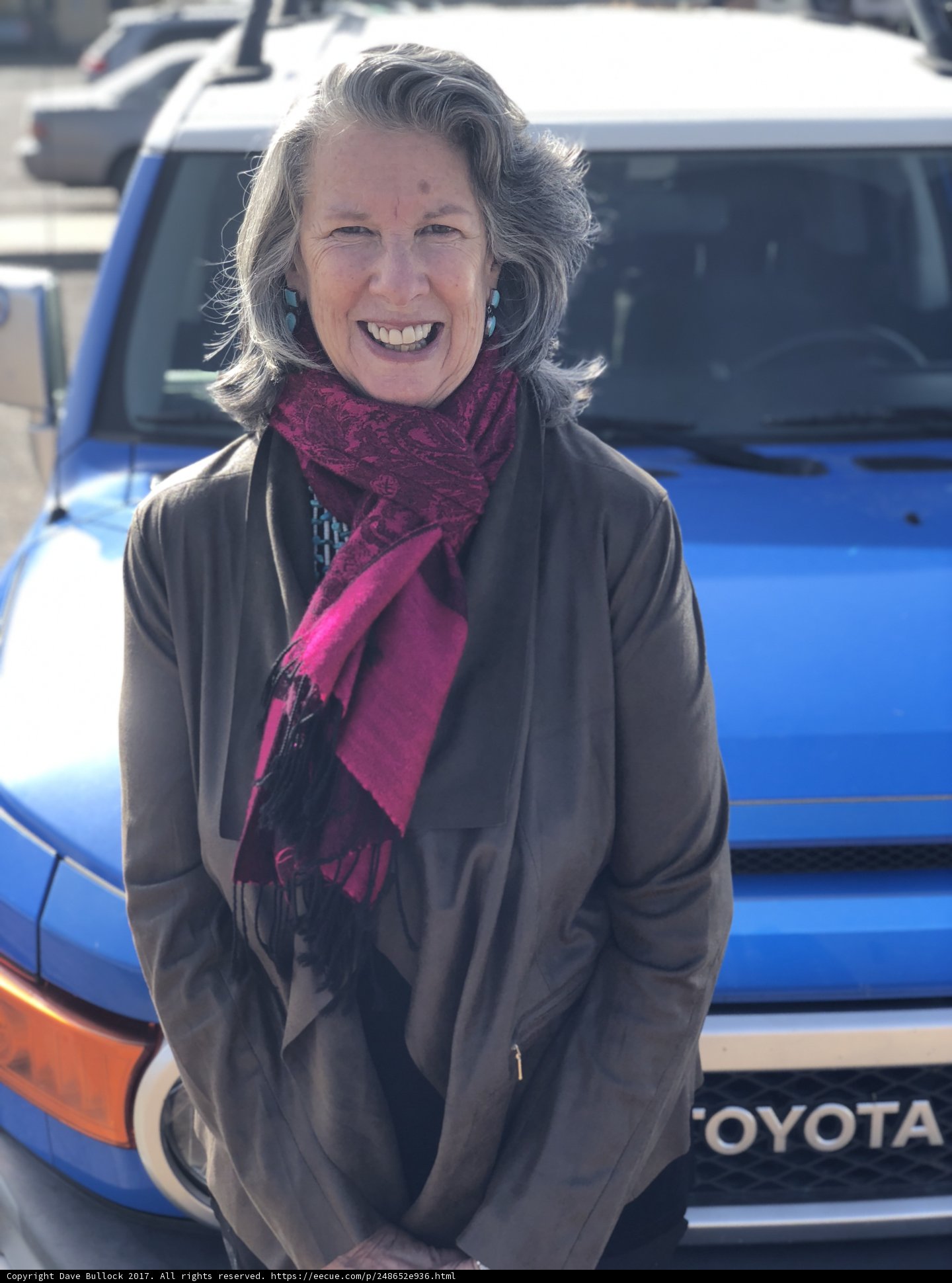 Smiling Lady Poses in Front of Blue Toyota Truck